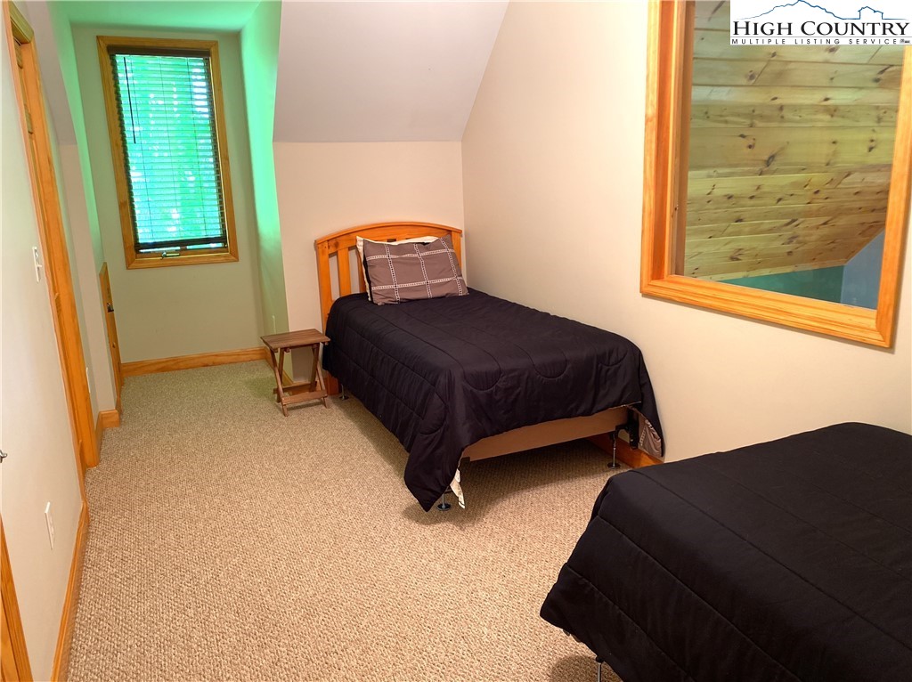 402 Pinnacle Ridge Road Beech Mountain, NC 28604 - Photo 29 of 44 a bedroom with a bed lamp and a window