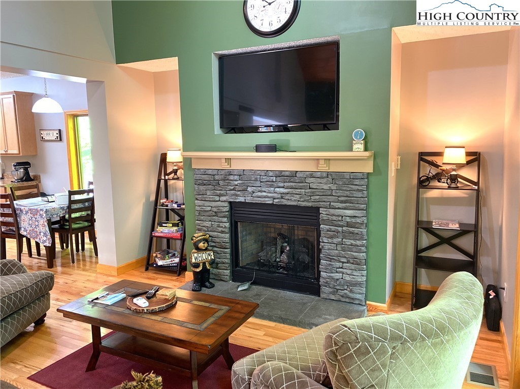 402 Pinnacle Ridge Road Beech Mountain, NC 28604 - Photo 3 of 44 a living room with furniture a flat screen tv and a fireplace
