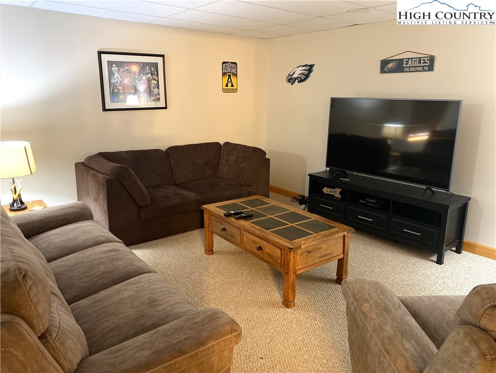 402 Pinnacle Ridge Road Beech Mountain, NC 28604 - Photo 32 of 44 a living room with furniture and a flat screen tv