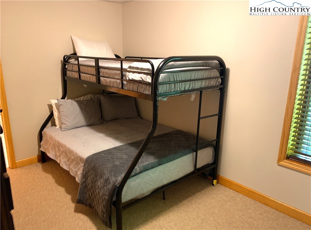 402 Pinnacle Ridge Road Beech Mountain, NC 28604 - Photo 36 of 44 a bedroom with a bed and window