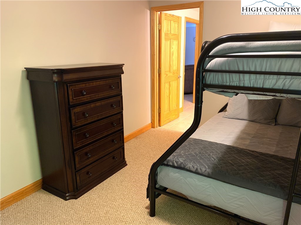 402 Pinnacle Ridge Road Beech Mountain, NC 28604 - Photo 37 of 44 a bedroom with a bed and window