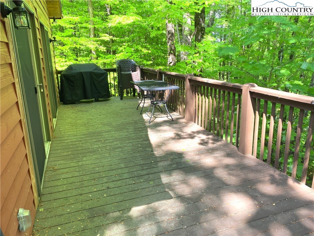 402 Pinnacle Ridge Road Beech Mountain, NC 28604 - Photo 40 of 44 a view of a porch with chairs and backyard