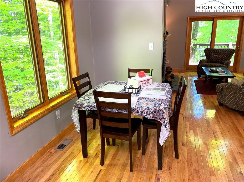 402 Pinnacle Ridge Road Beech Mountain, NC 28604 - Photo 10 of 44 a view of a dining room with furniture and a window