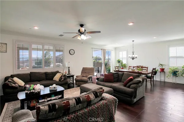 a living room with furniture kitchen view and a large window