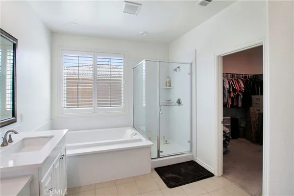 a bathroom with a tub a sink and a shower