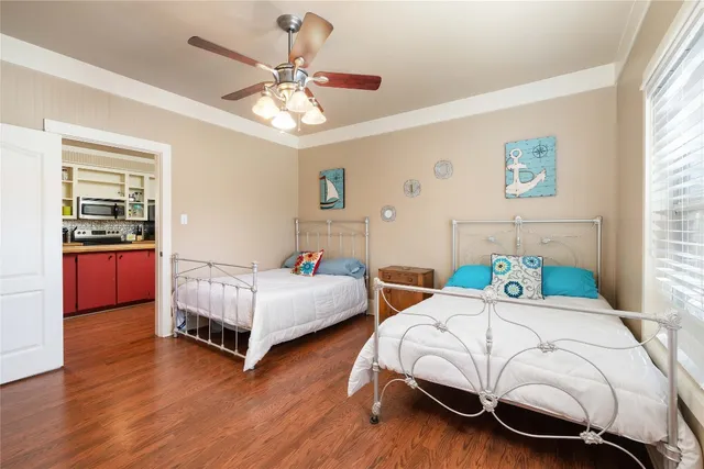 a bedroom with two beds and a chandelier