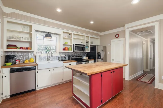 a kitchen with stainless steel appliances granite countertop a stove and refrigerator
