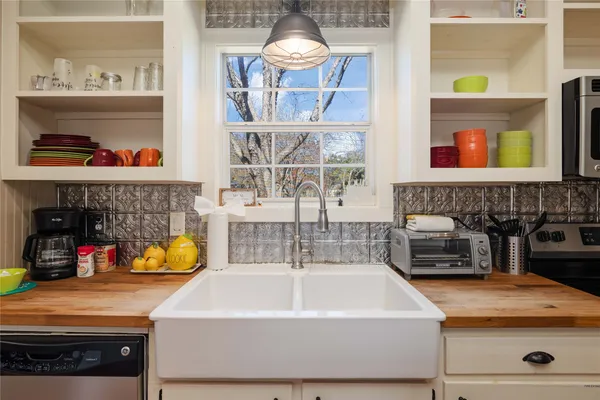 a kitchen with a sink and a stove next to a window