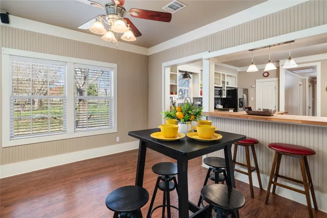 a view of a dining room with furniture and wooden floor