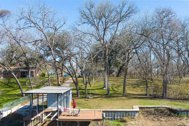 a living room with furniture a flat screen tv and a window