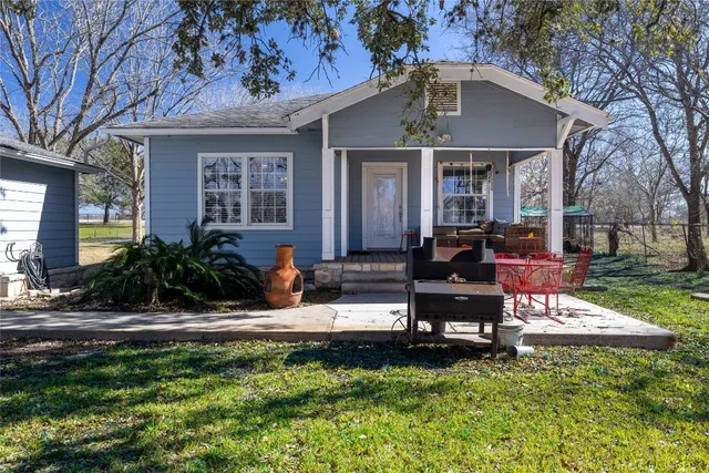 a view of a swimming pool with a yard