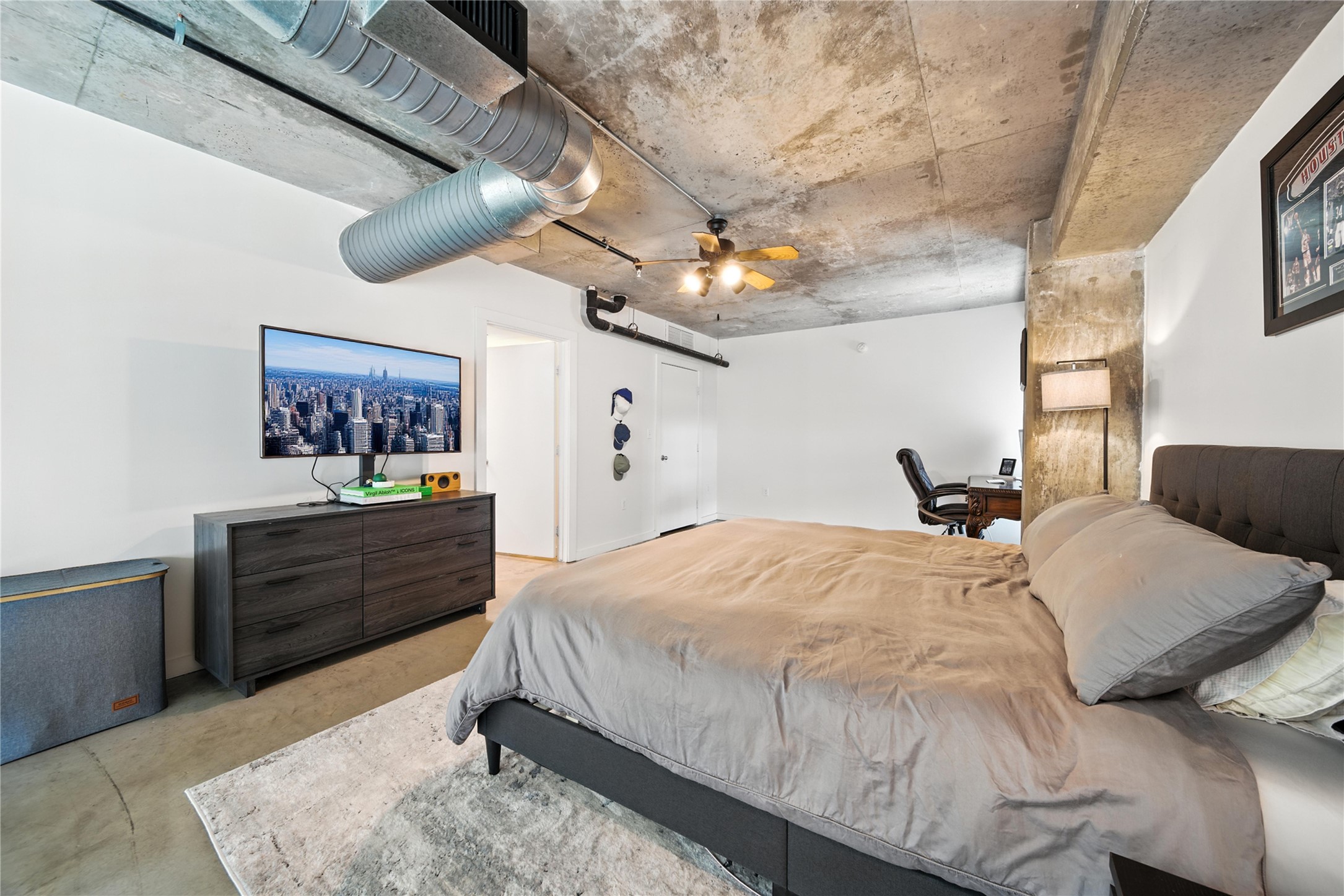 2000 Bagby Street, Unit 5423 Houston, TX 77002 - Photo 15 of 26 a bed room with a bed and a painting on the wall