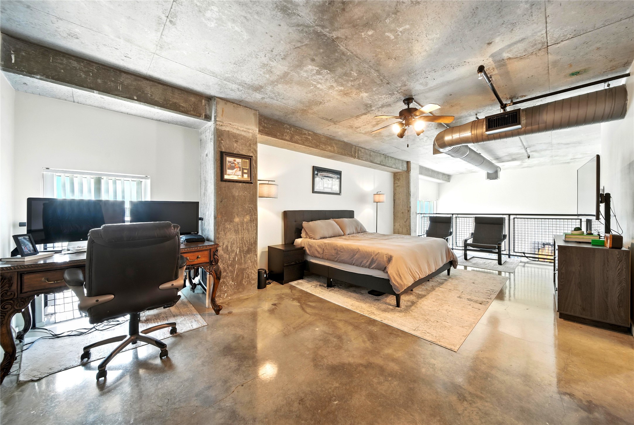 2000 Bagby Street, Unit 5423 Houston, TX 77002 - Photo 16 of 26 a bedroom with a bed gym equipment and a desk