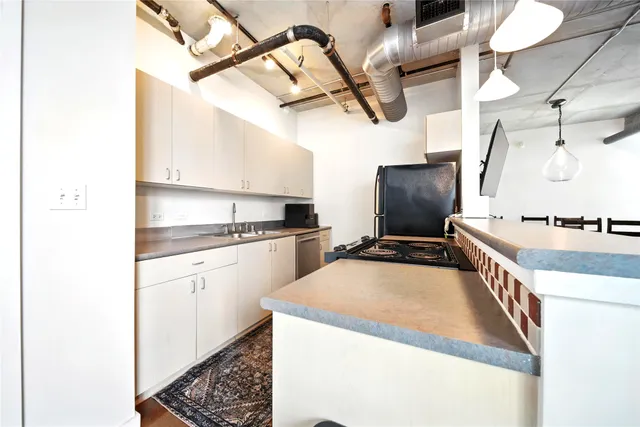 a kitchen with stainless steel appliances a sink and cabinets