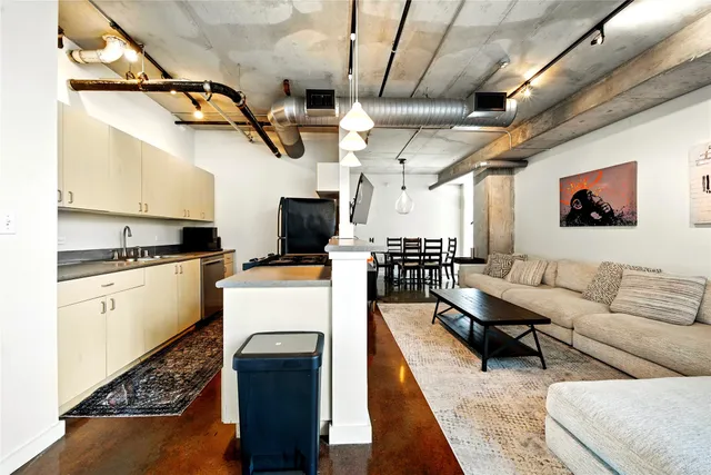 a living room with furniture and kitchen view