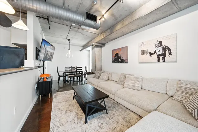 a living room with furniture and wooden walls