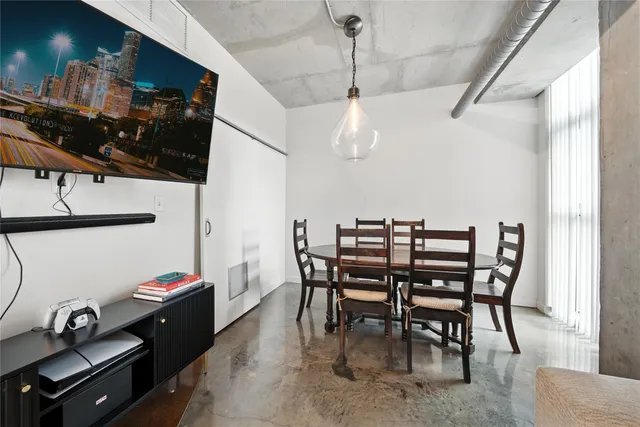 a view of a dining room with furniture and a chandelier
