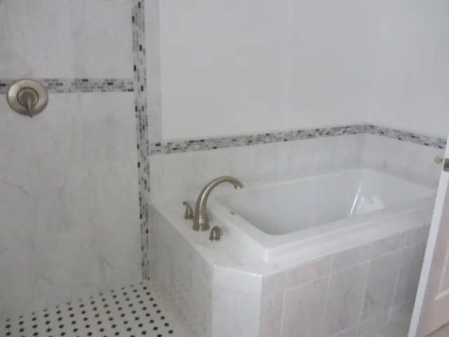 a bathroom with a sink toilet and window