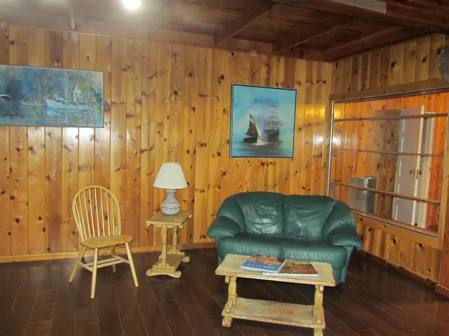 a view of a closet with wooden floor