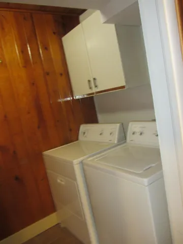 a bed sitting in a spacious bedroom next to a window