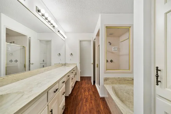 a spacious bathroom with a shower and a sink
