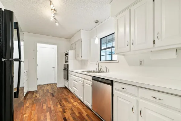 a kitchen with a sink stove and refrigerator