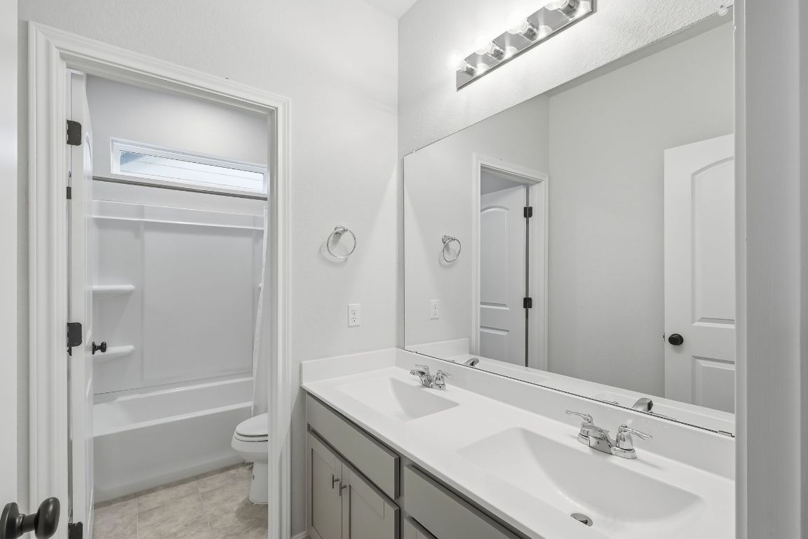 1941 Winston Way Leander, TX 78641 - Photo 21 of 28 Full bathroom with double vanity and shower / bathtub combination