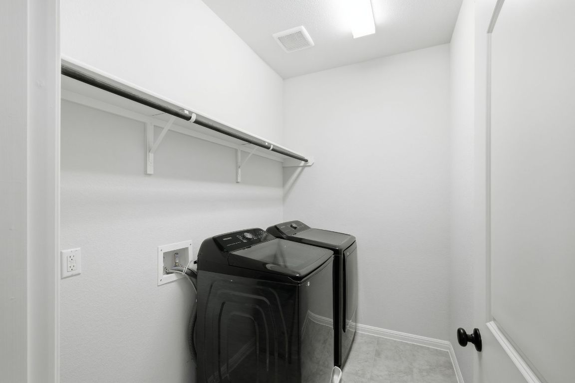 1941 Winston Way Leander, TX 78641 - Photo 22 of 28 Laundry room with independent washer and dryer and baseboards