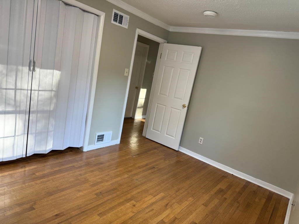 1232 South White Station Road Memphis, TN 38117 - Photo 11 of 21 a view of an empty room with wooden floor and door