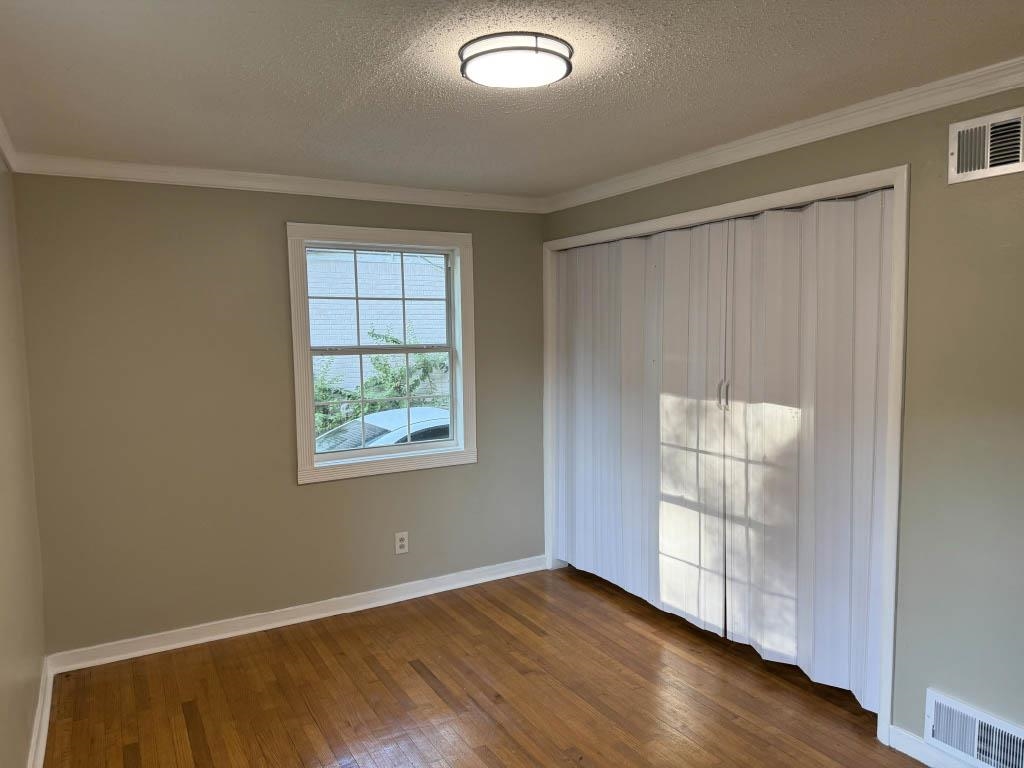 1232 South White Station Road Memphis, TN 38117 - Photo 9 of 21 an empty room with wooden floor and windows
