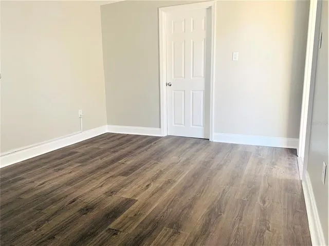 a view of a room with wooden floor