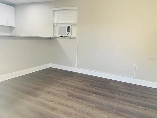 a view of a room with wooden floor