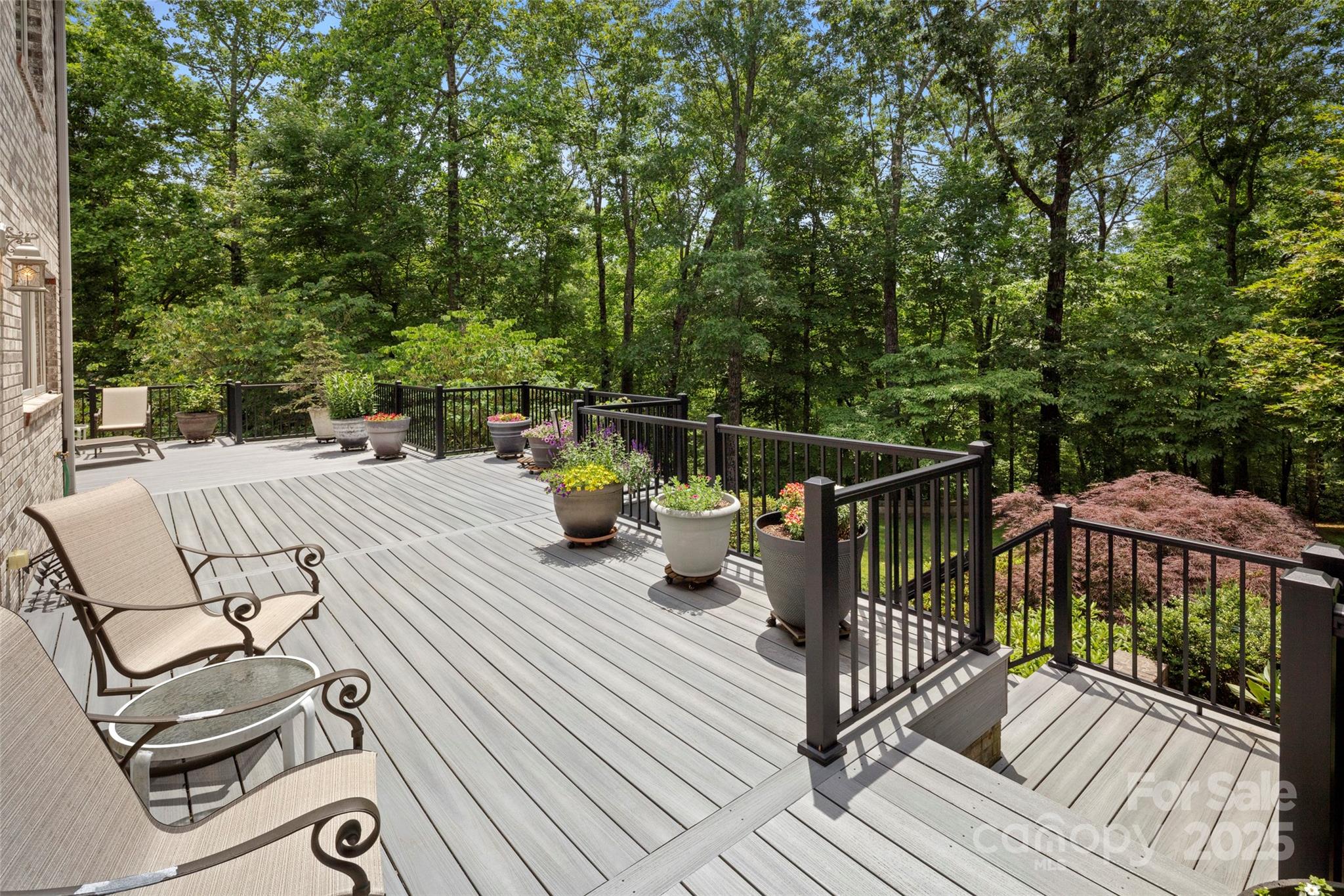 421 North Boundary Road Mill Spring, NC 28756 - Photo 13 of 43 a view of a patio with table and chairs and wooden floor