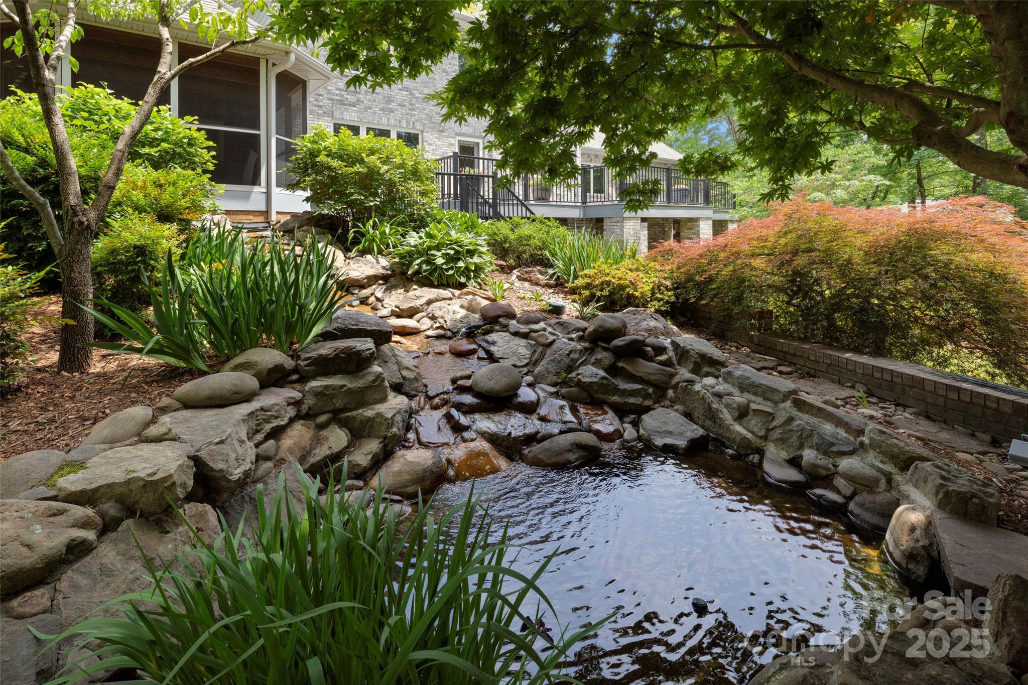 421 North Boundary Road Mill Spring, NC 28756 - Photo 14 of 43 a view of a large yard with plants and large trees