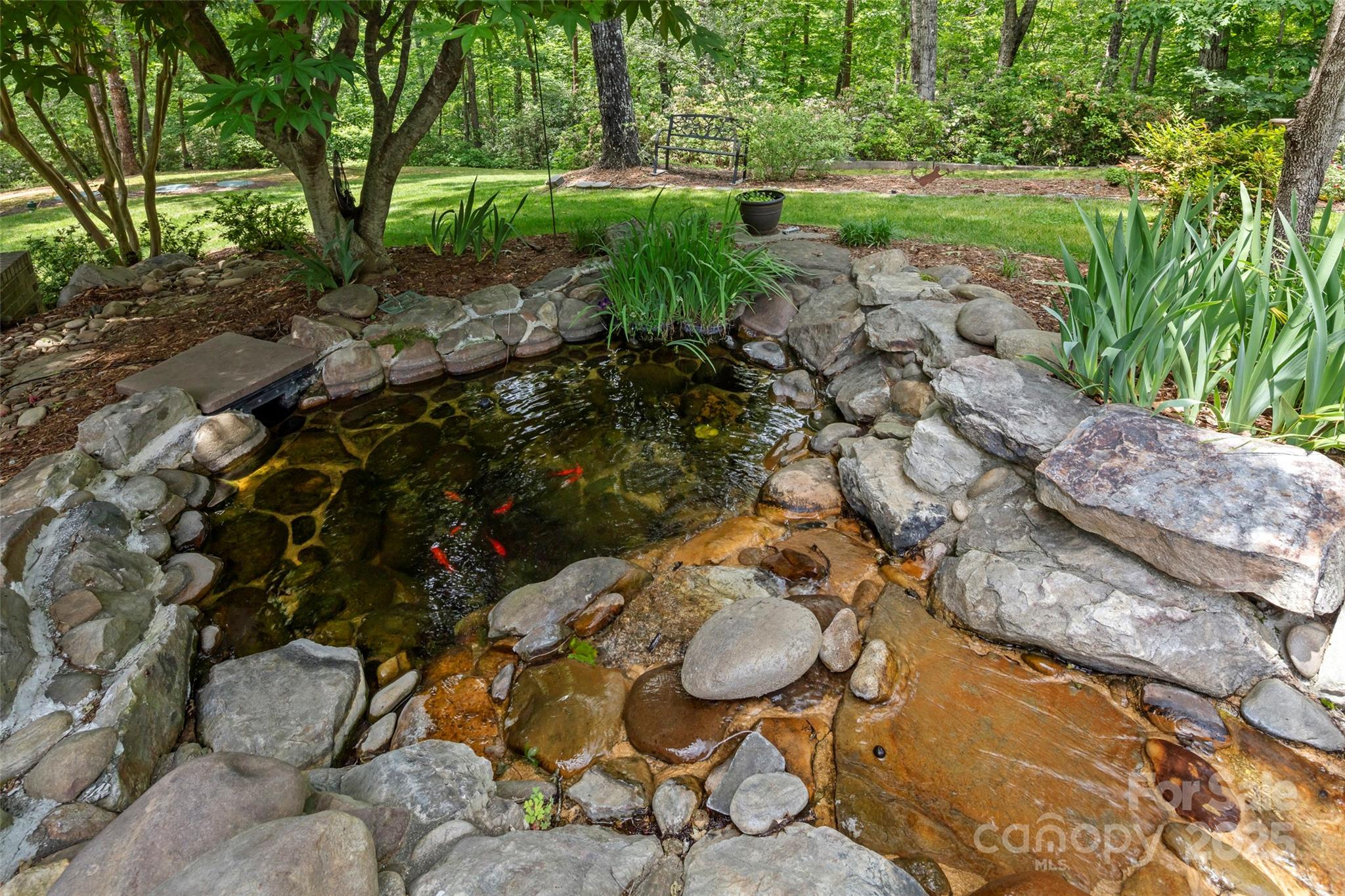421 North Boundary Road Mill Spring, NC 28756 - Photo 15 of 43 a backyard of a house with yard and outdoor seating