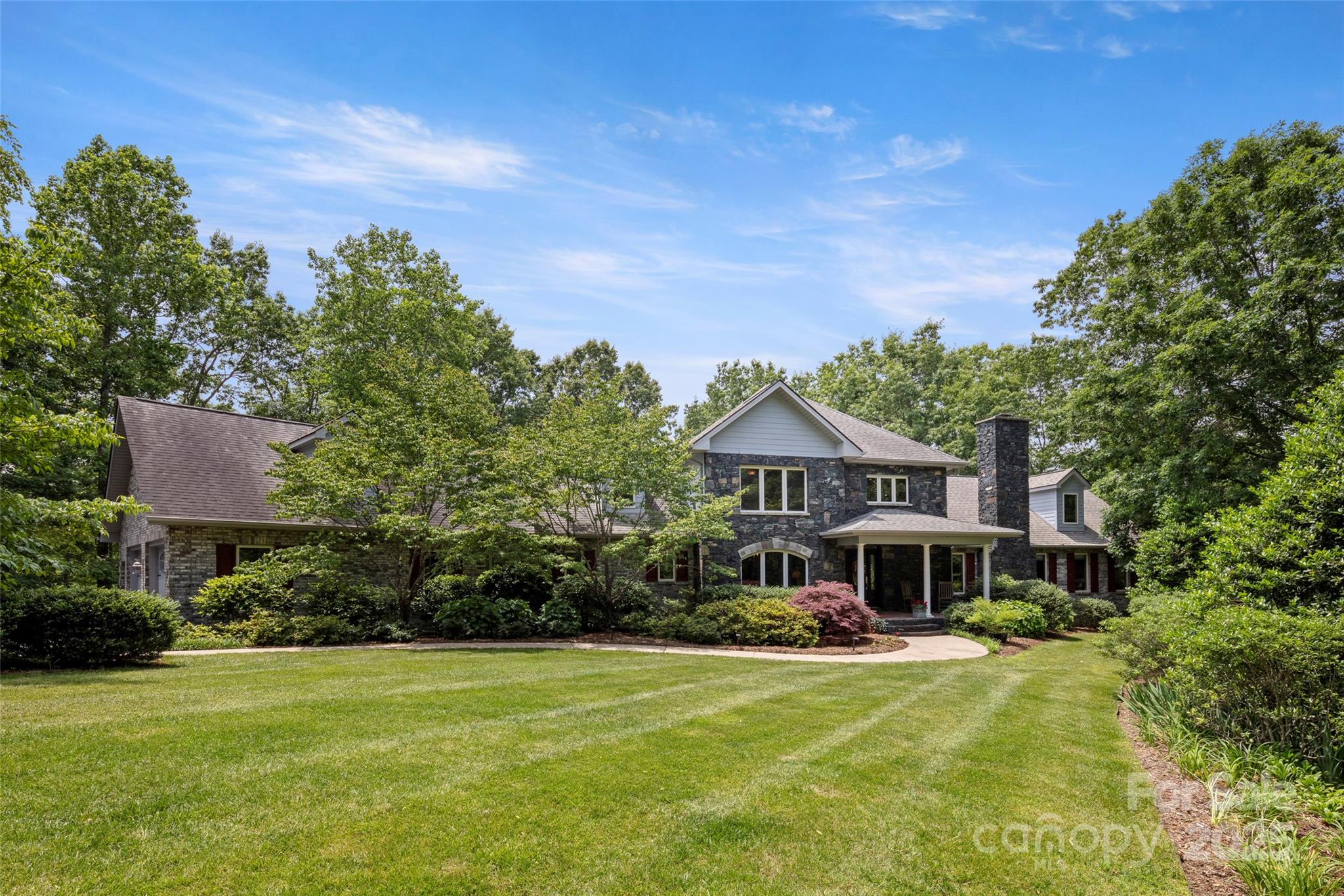 421 North Boundary Road Mill Spring, NC 28756 - Photo 2 of 43 a front view of a house with a yard table and chairs