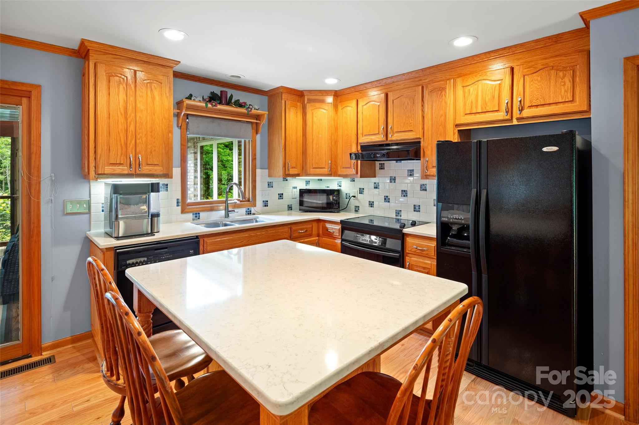 421 North Boundary Road Mill Spring, NC 28756 - Photo 24 of 43 a kitchen with stainless steel appliances granite countertop a refrigerator a sink a stove and island