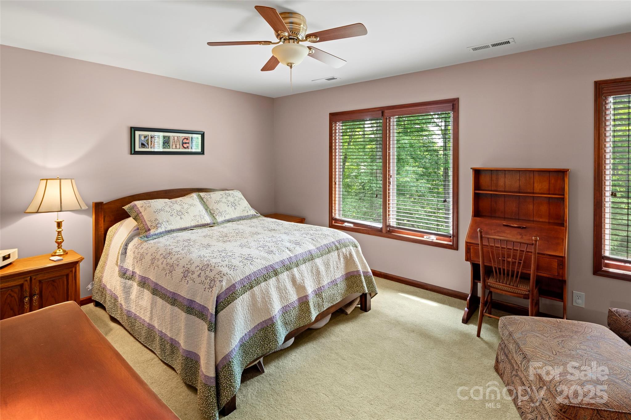 421 North Boundary Road Mill Spring, NC 28756 - Photo 28 of 43 a spacious bedroom with a bed and a table in it