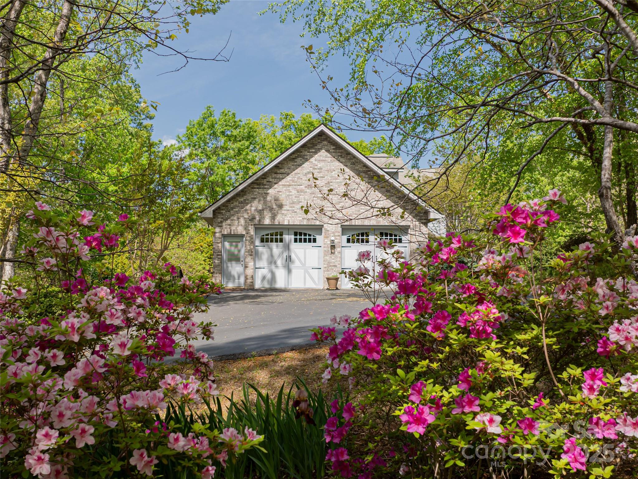 421 North Boundary Road Mill Spring, NC 28756 - Photo 34 of 43 a view of a house with a flower garden