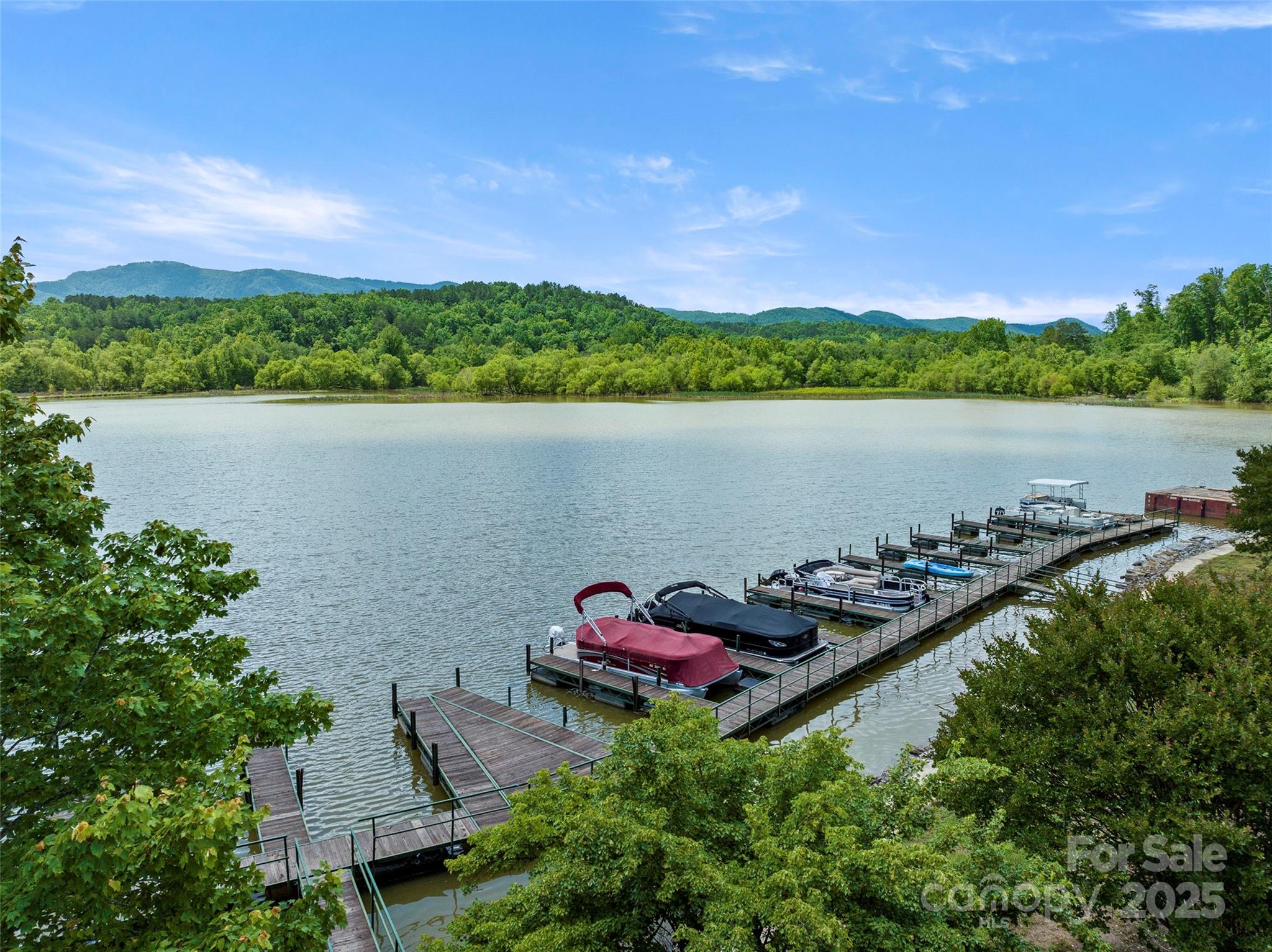 421 North Boundary Road Mill Spring, NC 28756 - Photo 5 of 43 a view of a lake with a house in the background