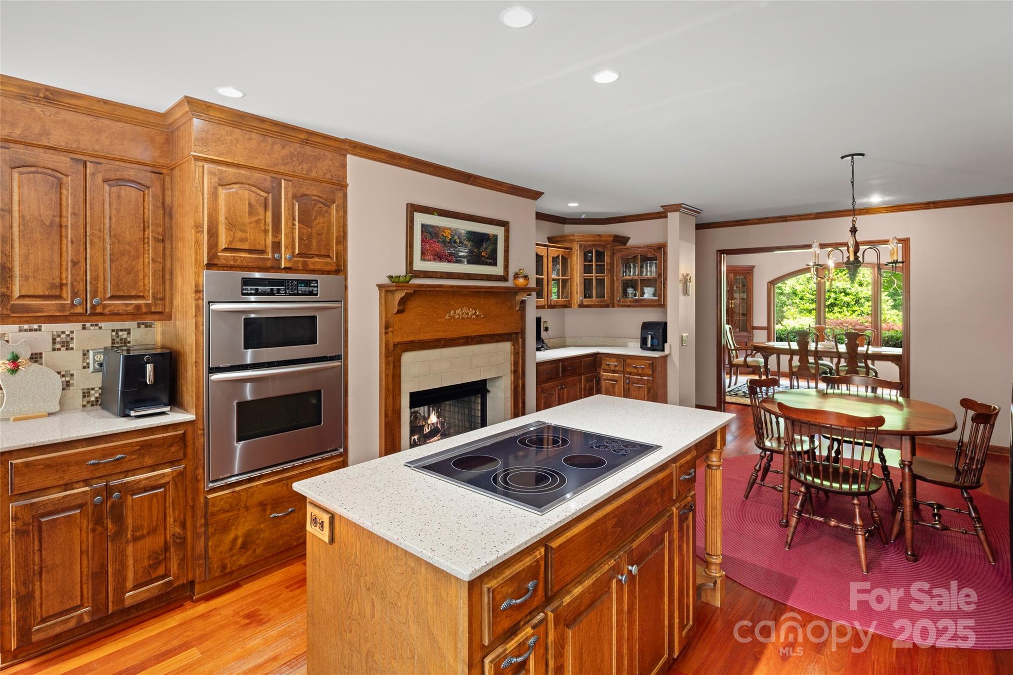 421 North Boundary Road Mill Spring, NC 28756 - Photo 9 of 43 a kitchen with stainless steel appliances granite countertop a stove top oven a sink dishwasher and a dining table with wooden floor
