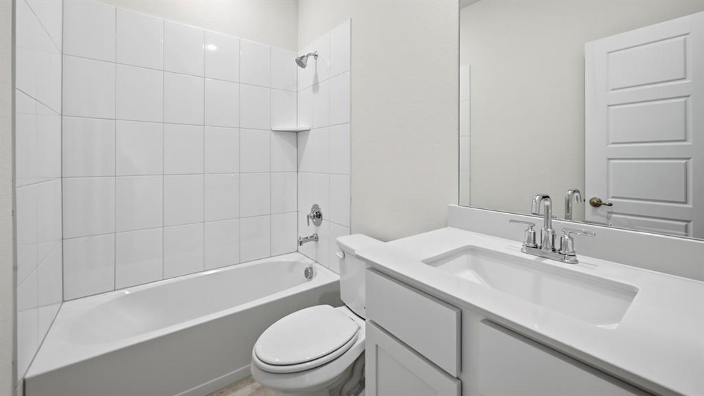 2432 Grapevine Way Celina, TX 75009 - Photo 1 of 1 a bathroom with a sink a toilet and shower