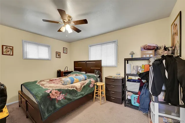 a living room with furniture and a book shelf