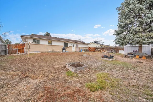 a view of a backyard with swimming pool