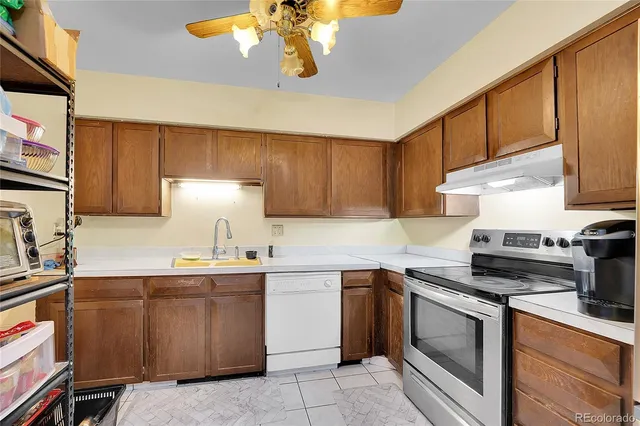 a kitchen with refrigerator and cabinets