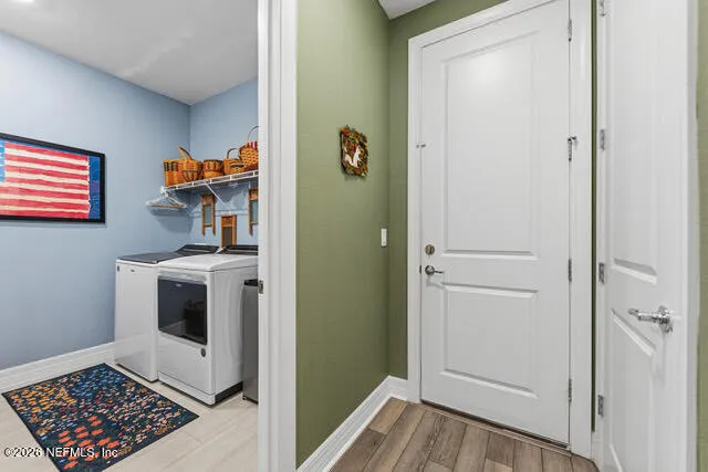 a view of a house with a yard and potted plants