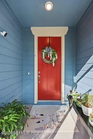a room with painting on the wall and a potted plant