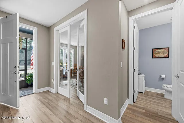 a kitchen with cabinets and wooden floor