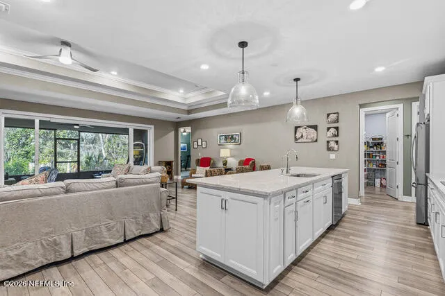 a kitchen with stainless steel appliances granite countertop a refrigerator a sink and a stove