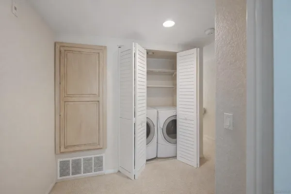 a view of a storage & utility room with washer and dryer